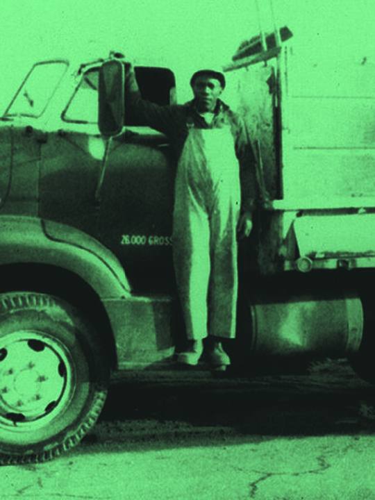 Driver standing on his truck