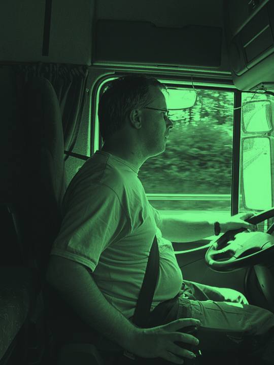 Truck driver in the cab of a semi