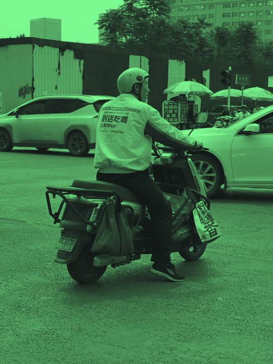 Courier riding a delivery scooter