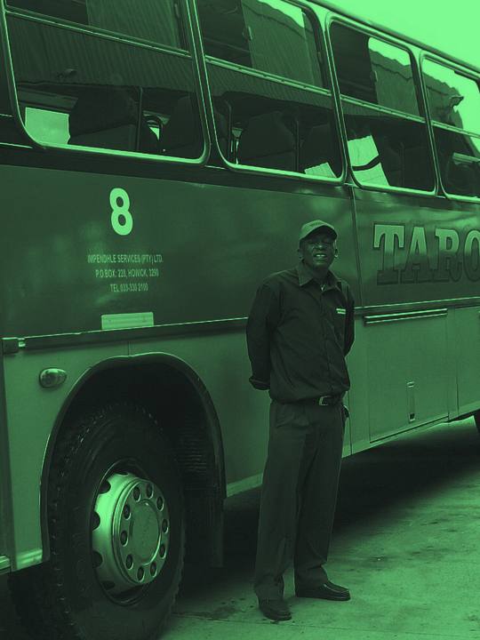 Bus driver beside his coach
